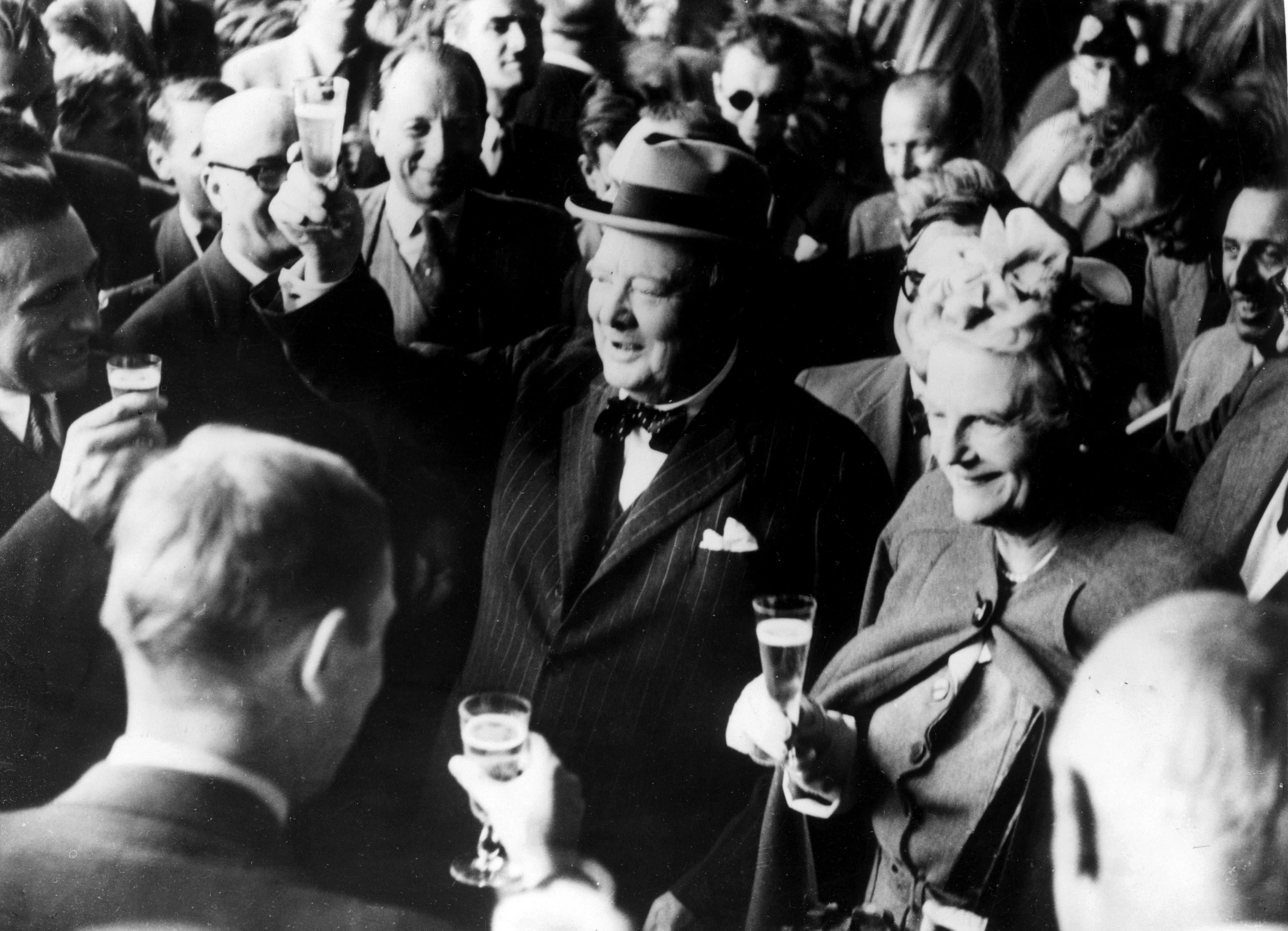 26th August 1946:  Former British prime minister Winston Leonard Spencer Churchill (1874 - 1965) and his wife Clementine make a toast upon their arrival in Switzerland.  (Photo by Keystone/Getty Images)
