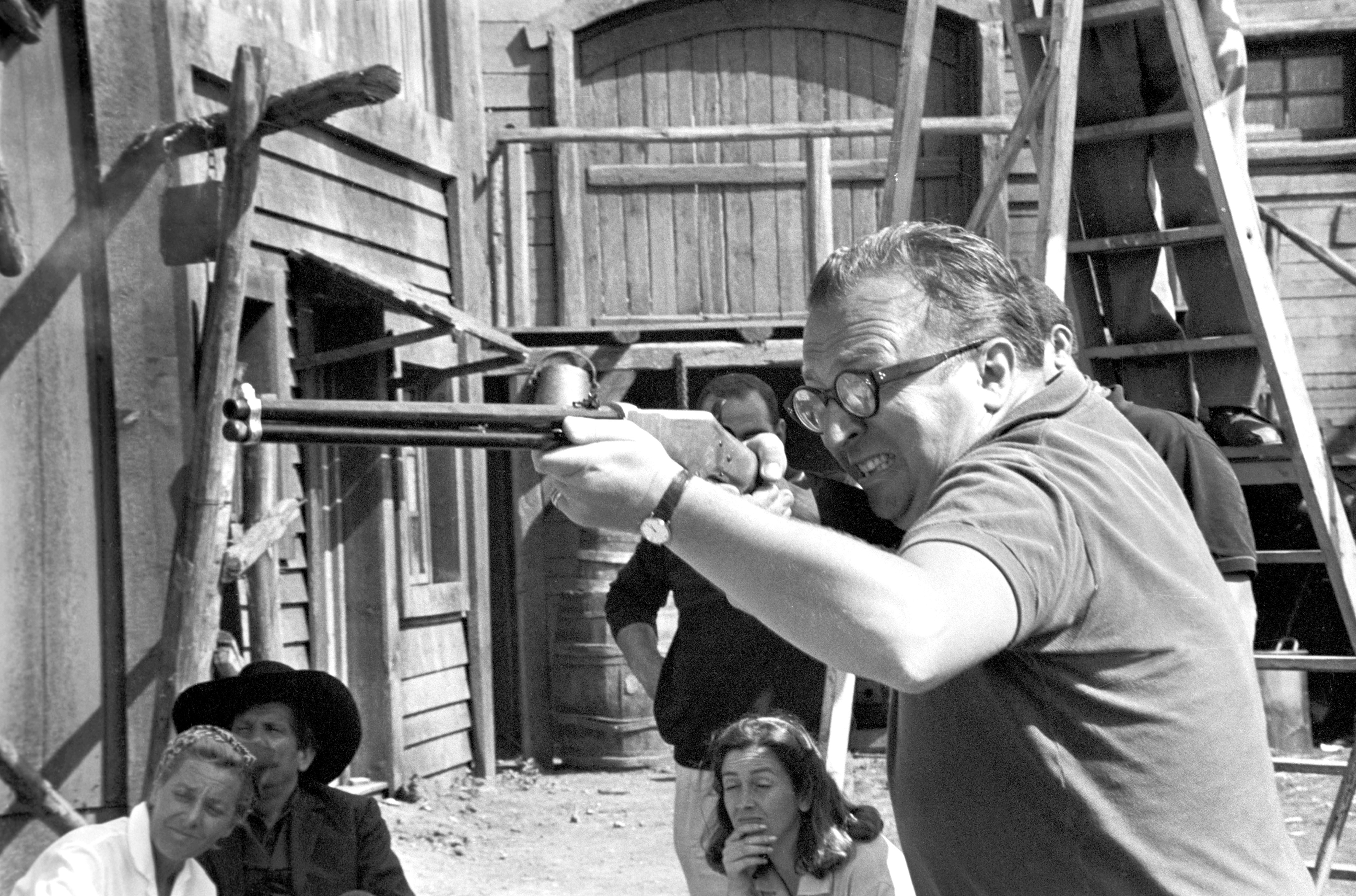 The director Sergio Leone shooting with a rifle on the set of the film The Good, the Bad and the Ugly. 1966 (Photo by Reporters Associati & Archivi/Mondadori Portfolio via Getty Images)